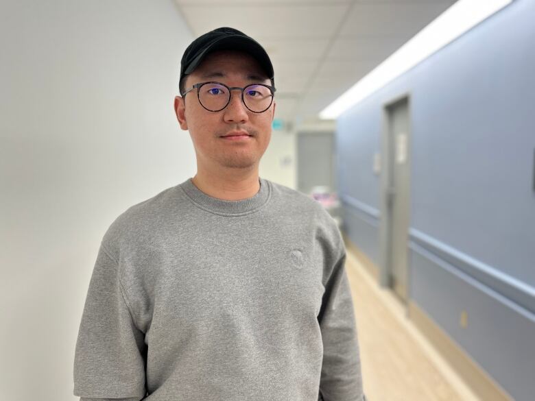 Gary Wang, who was was diagnosed with stomach cancer in August 2020, is pictured in a hallway at Princess Margaret Cancer Centre.