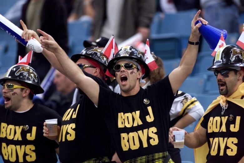 Hamitlon Tiger-Cats fans whoop it up int he stand at B.C. Place prior to the kickoff of the 87th Grey Cup in Vancouver Sunday,  Nov. 28, 1999. 