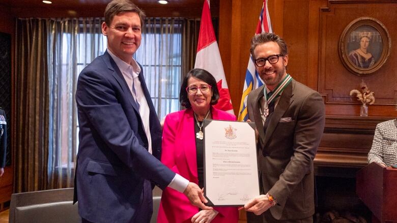 Actor Ryan Reynolds, right, who was born, and grew up in Vancouver B.C., received the Order of B.C. from Premier David Eby, left, and Lieutenant Governor Janet Austin.