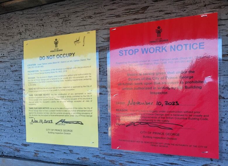 Red and yellow laminated notices that read in bold DO NOT OCCUPY and STOP WORK NOTICE.