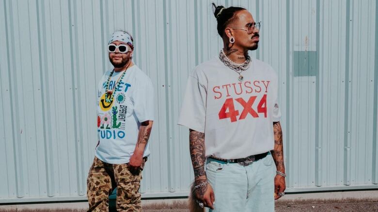 Two men, both dressed in white posing for an album shot