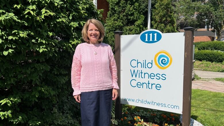 Picture of Robin Heald, the executive director of Child Witness Centre (CWC), in front of their office.