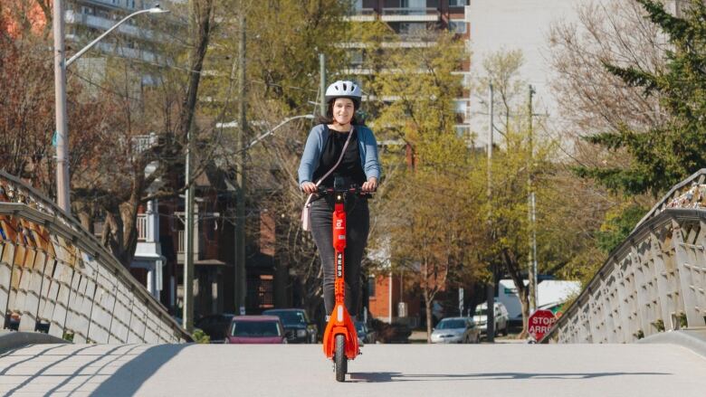 A person rides an e-scooter.