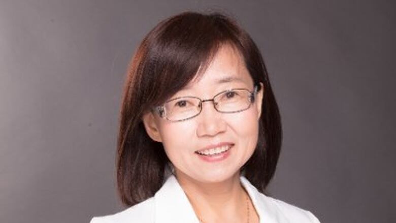 An East Asian woman smiles in a headshot.