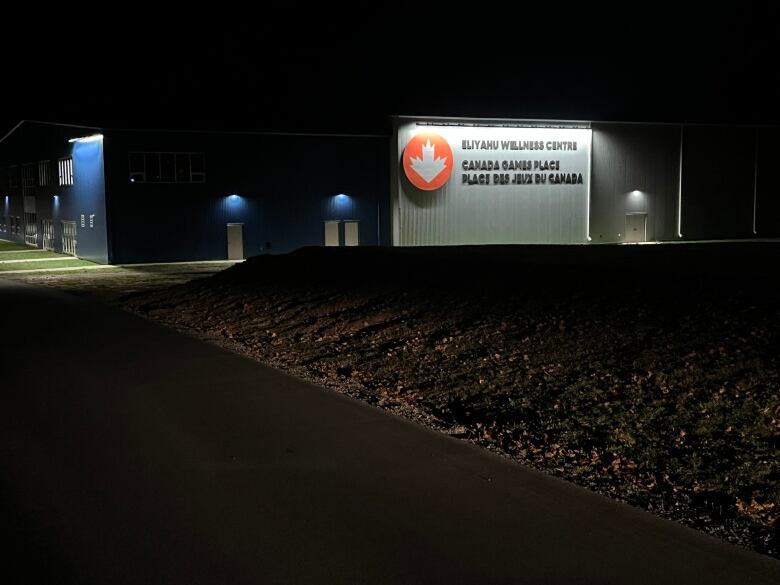 A photo taken at night shows the lights of the rink illuminating the sign welcoming people to the new rink. 