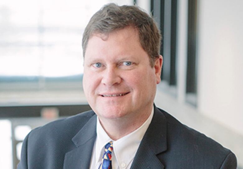 A man with brown hair and a suit. 