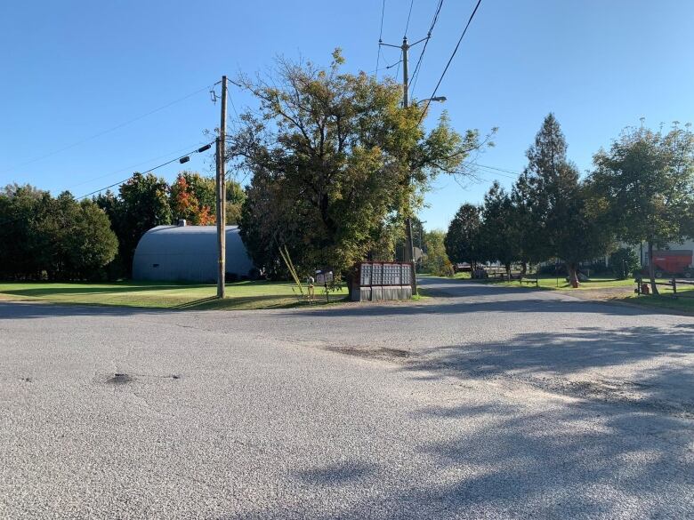 An empty street with a postal box.