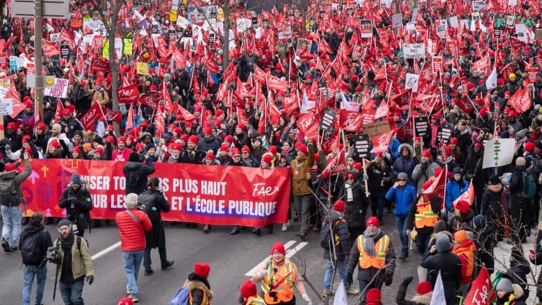 Union members pack march on a packed road in Montreal.