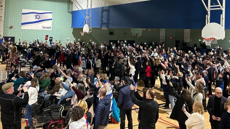 A group of people holding up lights