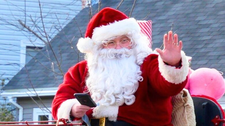 Santa waves from a float.