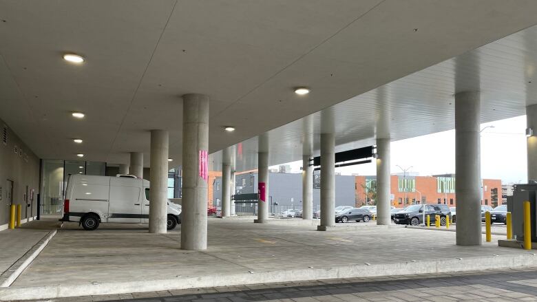 Cement columns hold up part of a building that allows for covered parking