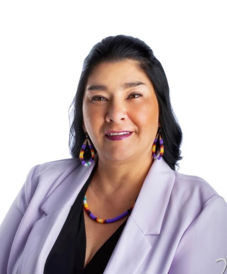 An Indigenous woman with beaded earrings.