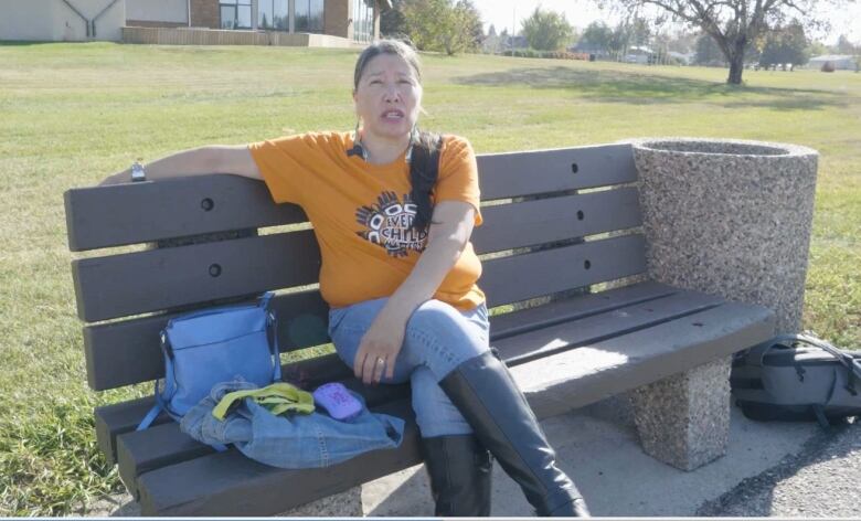 Cathy Wheaton-Bird sits on a bench in Prince Albert, Sask.