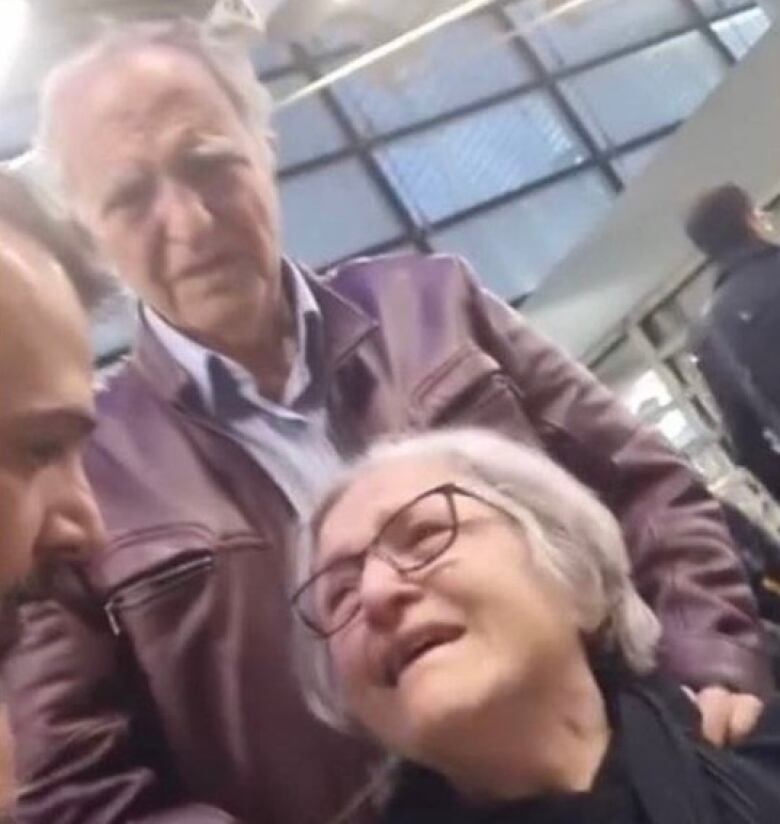 An elderly couple at an airport.