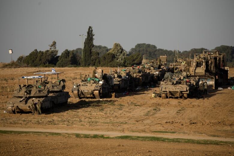 Israeli tanks and armoured vehicles are seen parked along a stretch of the southern border Israel shares with Gaza.