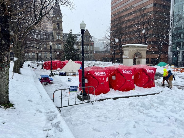 Red box-like shelters in front of a building.