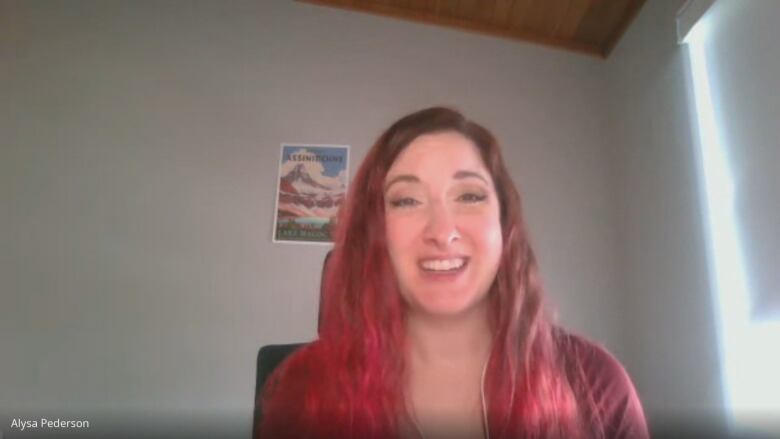 A young woman in pink long hair smiling 