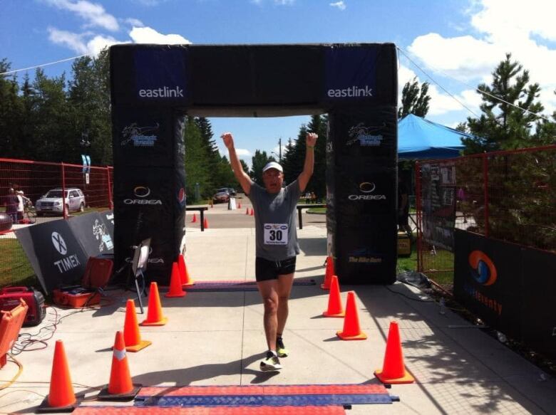 Troy crosses a finish line at a different race.