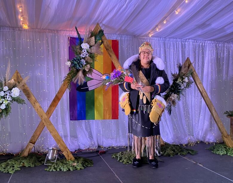 A two-spirit princess on stage at an event. 