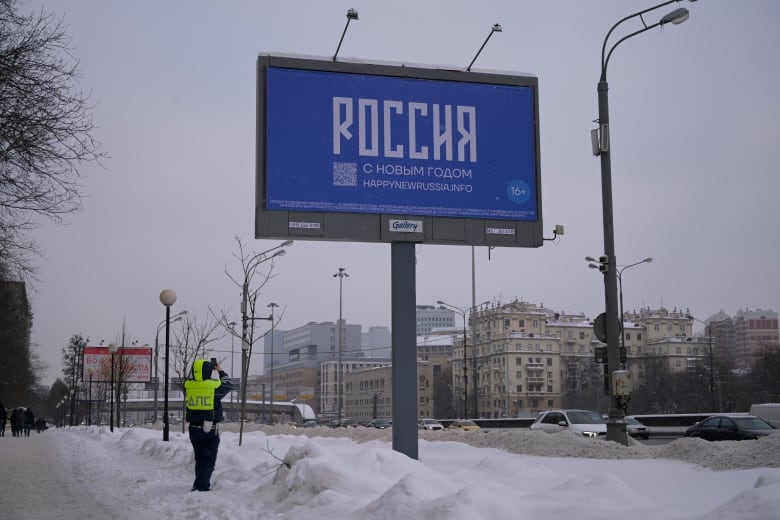 A billboard with Russian characters is shown.