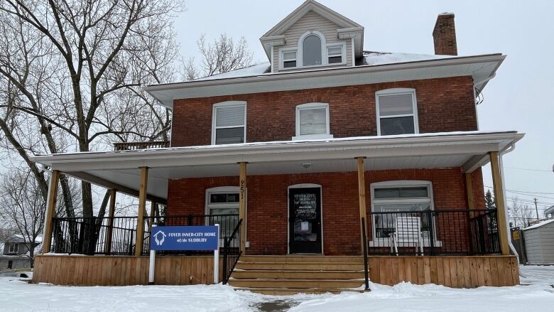 An old building with a sign that says Inner-City Home in the front.