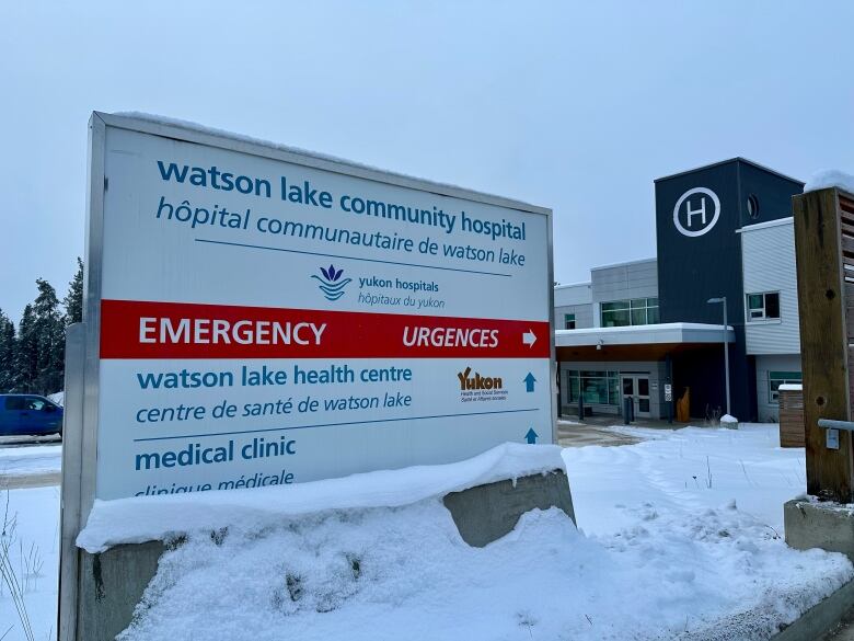 A sign outside a hospital building in winter.