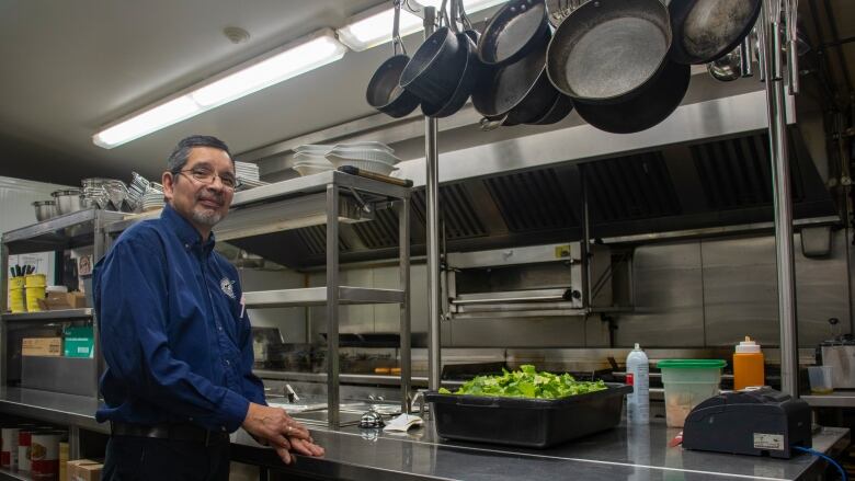 A man stands in a kitchen.