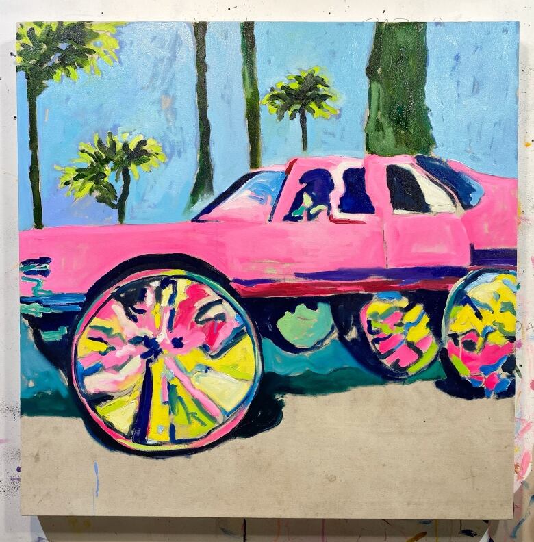 A colourful painting shows a pink vehicle and has palm trees in the background.