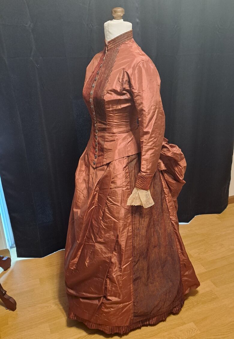 This 1880s-era silk bustle dress has a secret pocket under the skirt, where the two paper sheets containing the Silk Dress cryptograph were found