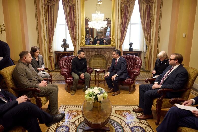 Group of people seated in room