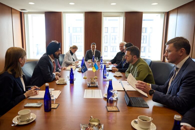 Board room table. Zelensky and Banga seated across from each other