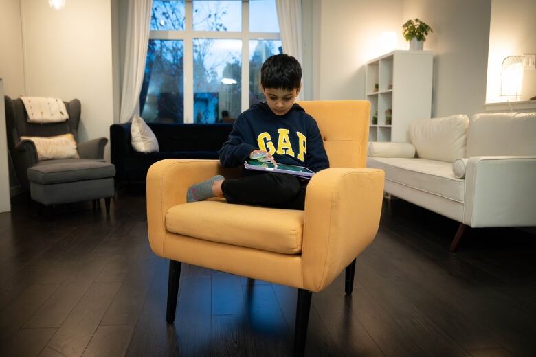 Rohan, 8, plays a LittleLit game on a tablet that uses AI to personalize the learning experience in Coquitlam, B.C. 