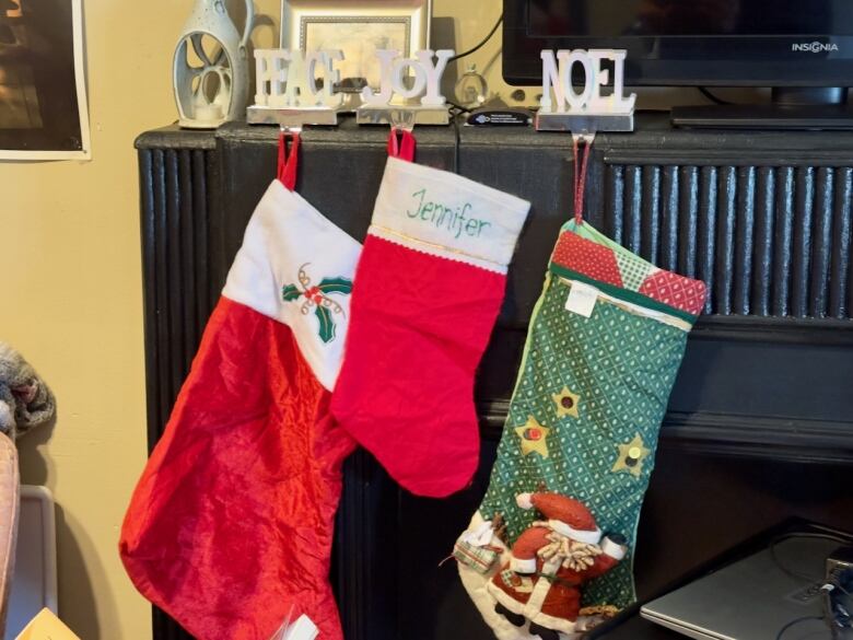 Christmas stockings hang from a mantle. 