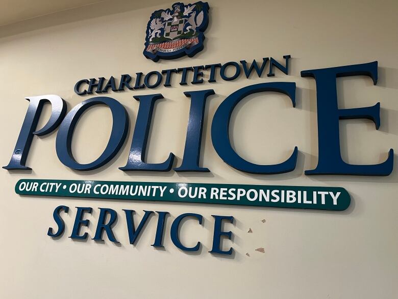 A logo of Charlottetown police, in blue, on the wall of police headquarters. 