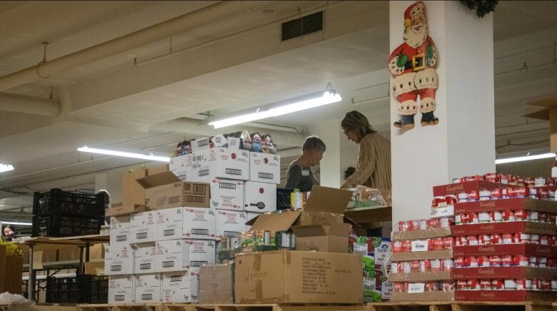 People pack christmas hampers.