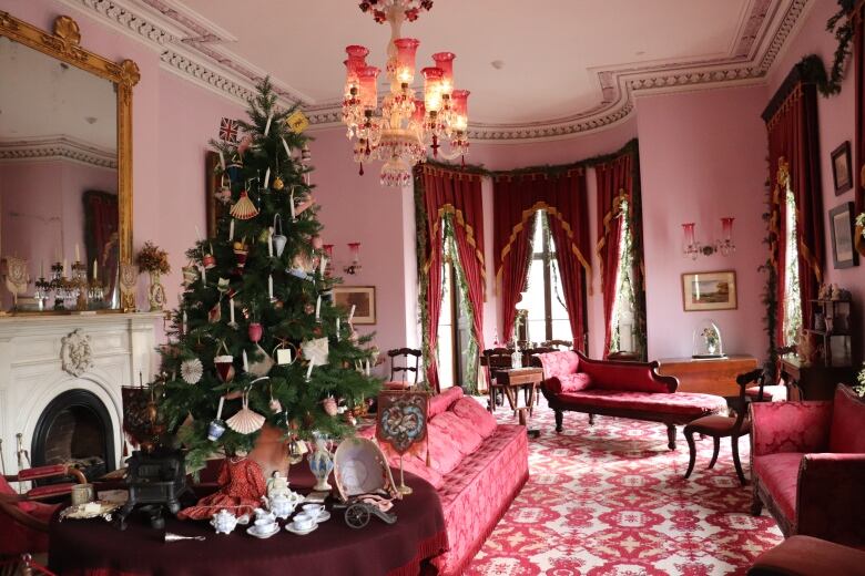 A Christmas tree in a Victorian living room. 