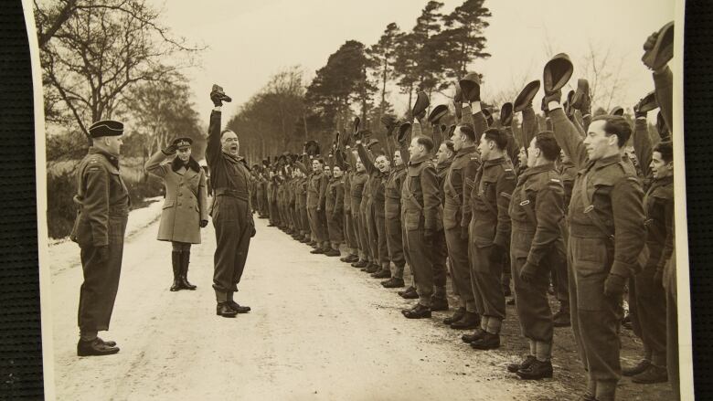 A black and white photo shows the West Nova Scotia Regiment singing.