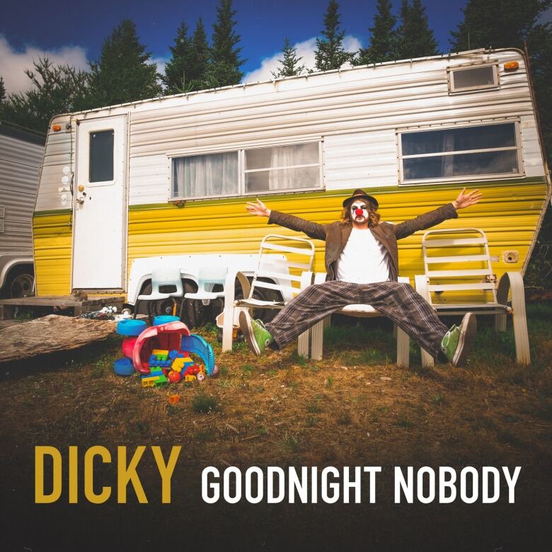 A man dressed as a clown sits with legs and arms outstretched in front of a trailer. Across the bottom is the text Dicky, Goodnight Nobody.