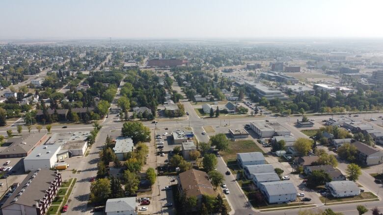 Image of the city taken from a drone, with hazy horizon