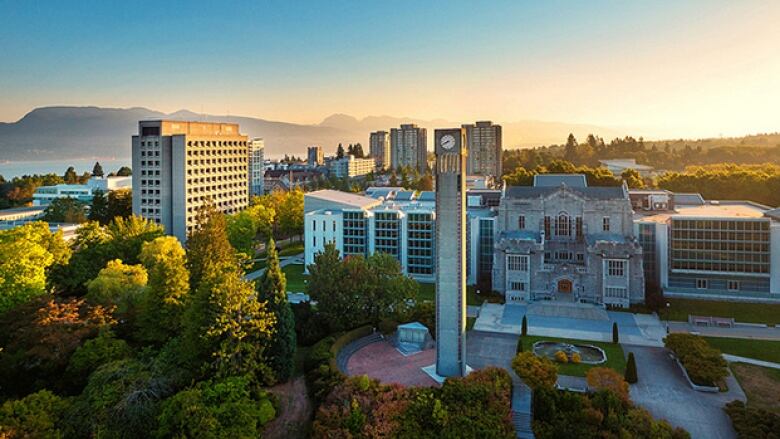 Landscape photo of the University of British Columbia. Views of a tower and several buildings behind it. 