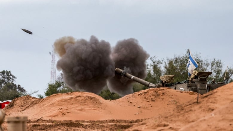 A tank fires a round.