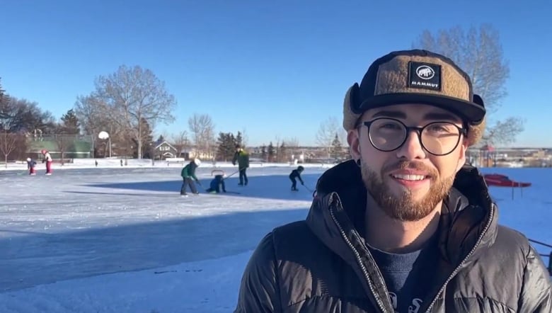 A man stands in front of an ice rink in Calgary.