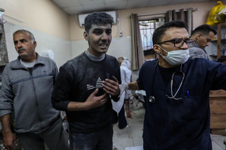 A Palestinian man injured in Gaza airstrikes is brought to a hospital.