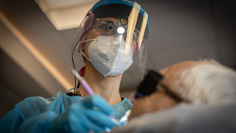 close up of dental hygenist working on patient