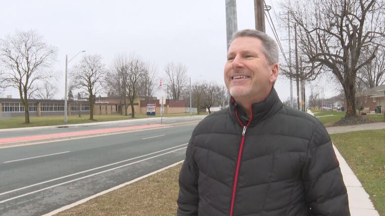 Man beside newly paved road. 