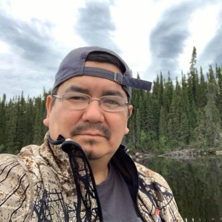 A man takes a selfie in the wilderness.