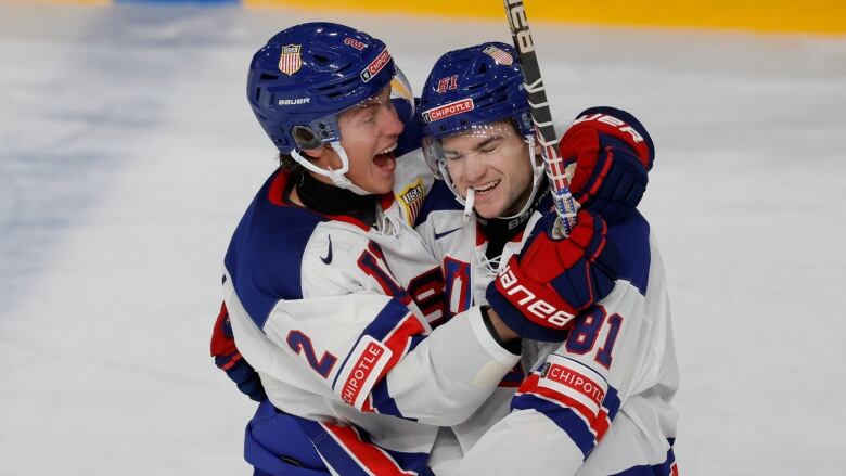 Two players hug after a goal.