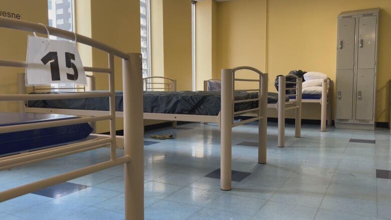 A photo shows a few empty shelter beds. 