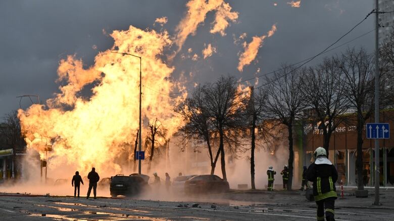 Firefighters rush to a large fire at a building.