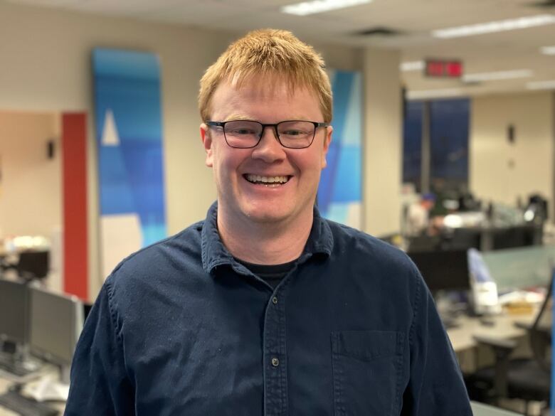 A man stands in the CBC Windsor newsroom. 